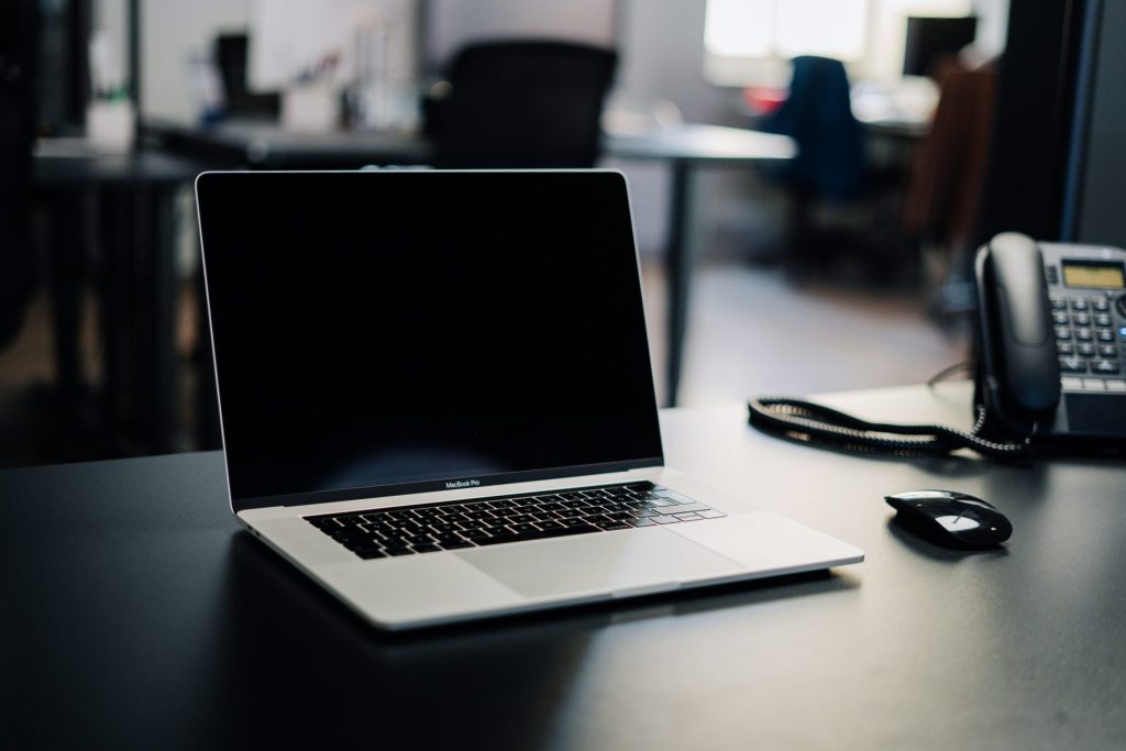 macbook pro on white table